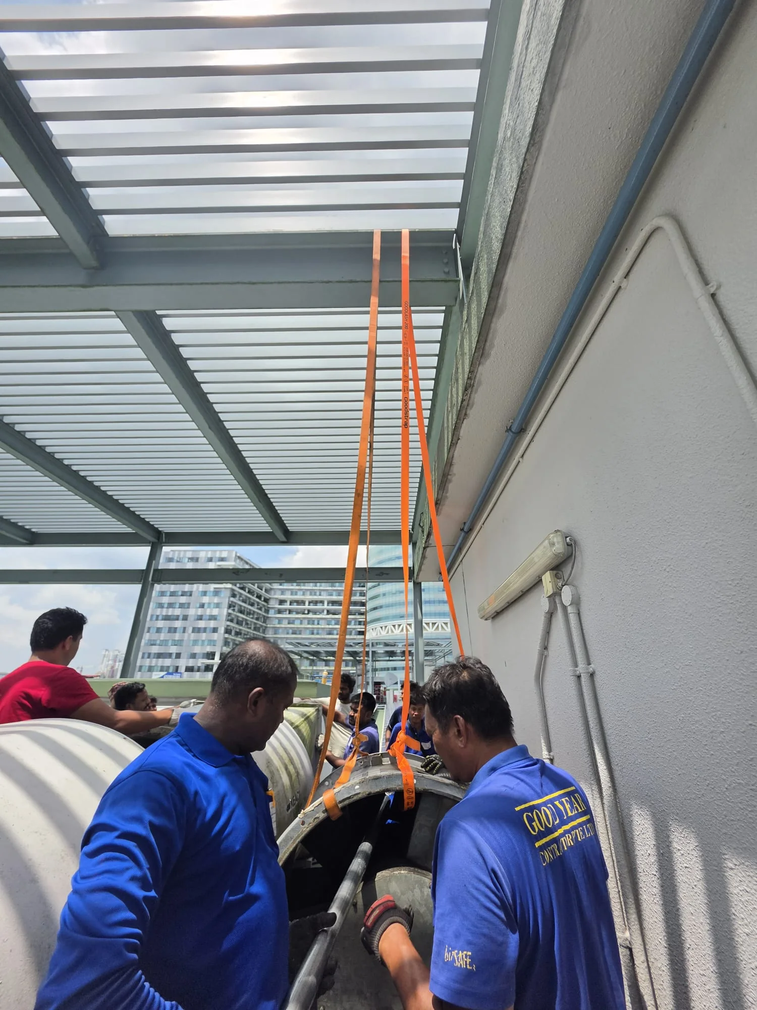 Rigging team positioning industrial equipment