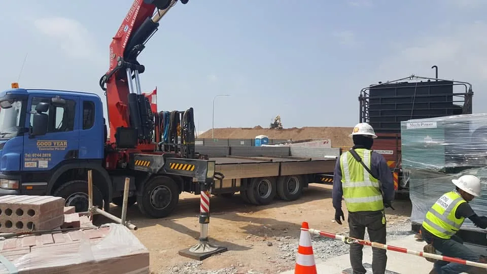 Lorry crane delivering industrial equipment to site